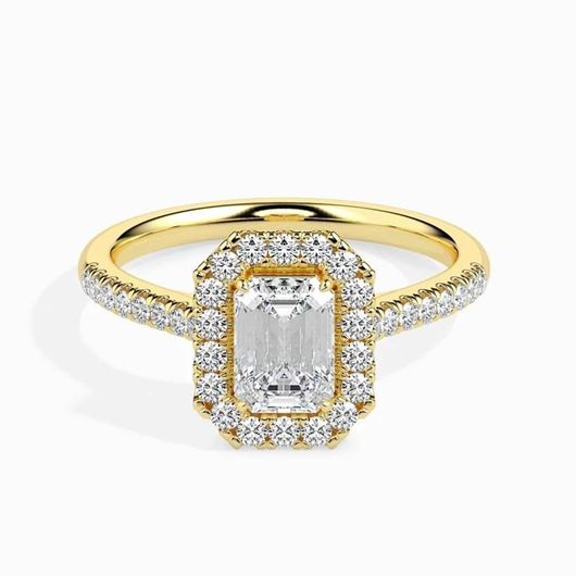 Foto de Sortija de oro amarillo con circonita central talla esmeralda y orla de circonitas blancas